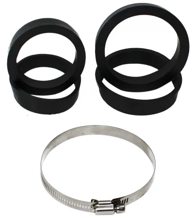 Black rubber adapter rings of various sizes are stacked on a white surface. At the bottom is a shiny metal hose clamp with an adjustment mechanism. Used to adapt a sports air filter.