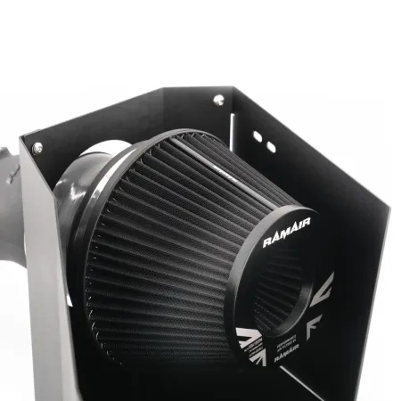 Close-up of the RamAir Proram intake kit for the Toyota GR Yaris. The black, conical air filter is mounted in a powder-coated heat shield. The RamAir logo is clearly visible. The kit promises optimized airflow.