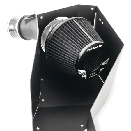 Close-up of the RamAir Proram intake kit for the Toyota GR Yaris. A black, conical air filter from RamAir is housed in a powder-coated heat shield. An intake pipe is attached to the side. The kit is shown against a white background.