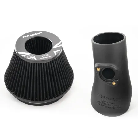 The RamAir Proram intake kit for the Toyota GR Yaris is shown. On the left is a conical, black air filter. On the right is a matte black, molded intake pipe with gold screws. Both parts are displayed on a white background.