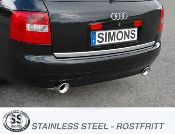 Rear view of a black Audi A6 (C5) with Simons Duplex sports exhaust system. Two round, silver tailpipes are visible. The license plate bears the name "Simons". The rear lights are red.