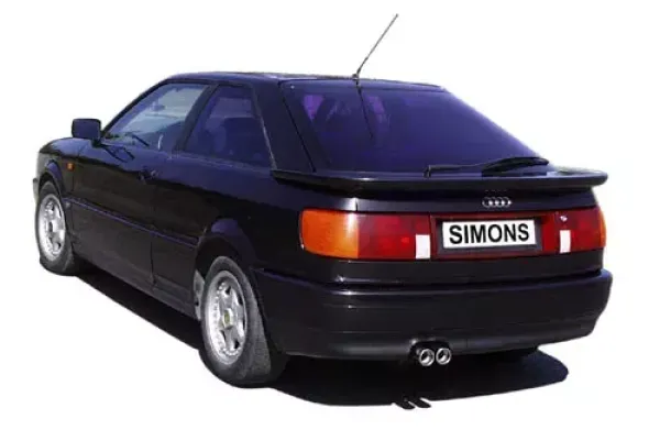 Rear view of a black Audi Coupé Type 89 with rear spoiler and Simons sports exhaust system. The tailpipes are 2x70 mm and made of stainless steel. The license plate shows the lettering "Simons".