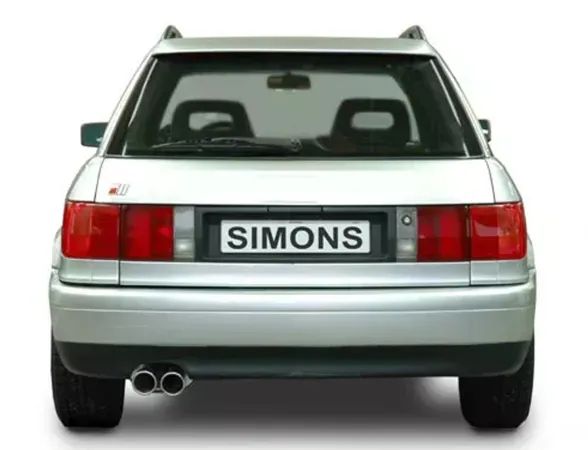 Rear view of a silver Audi S2 Avant/station wagon (B4) with rear lights, rear window and bumper. License plate "Simons" mounted. A twin-pipe sports exhaust from the stainless steel sports exhaust system is visible on the left.