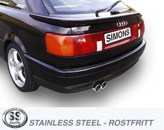 Rear view of a black Audi S2 Coupé. The focus is on the rear bumper with a Simons sports rear silencer made of stainless steel with two tailpipes. The Audi logo is visible.
