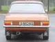 Rear view of a brown Opel Ascona A 1.6, 1.9 with chrome bumper, rear lights and license plate with the lettering Simons. A Simons sports exhaust made of aluminized steel with an oval tailpipe of 70 / 90mm can be seen under the vehicle.