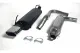 Exhaust system from Simons for SAAB 9-3: Black rear silencer with angular chrome tailpipe, curved pipe and silver silencer. Two pipe clamps are in the foreground, all on a white background.
